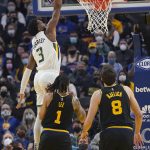 
              Utah Jazz guard Trent Forrest (3) dunks over Golden State Warriors guard Damion Lee (1) and forward Nemanja Bjelica (8) during the first half of an NBA basketball game in San Francisco, Sunday, Jan. 23, 2022. (AP Photo/Jeff Chiu)
            