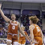 
              Texas forward Timmy Allen (0) celebrates with guard Devin Askew (5) in the second half of an NCAA college basketball game against TCU in Fort Worth, Texas, Tuesday, Jan. 25, 2022. (AP Photo/Gareth Patterson)
            