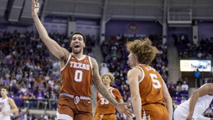 Texas forward Timmy Allen (0) celebrates with guard Devin Askew (5) in the second half of an NCAA c...