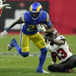 
              Los Angeles Rams running back Cam Akers (23) slips a tackle by Tampa Bay Buccaneers free safety Jordan Whitehead (33) during the second half of an NFL divisional round playoff football game Sunday, Jan. 23, 2022, in Tampa, Fla. (AP Photo/John Raoux)
            