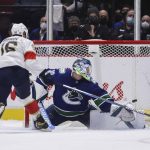 
              Florida Panthers' Aleksander Barkov, left, scores against Vancouver Canucks goalie Spencer Martin during the shootout in an NHL hockey game Friday, Jan. 21, 2022, in Vancouver, British Columbia. (Darryl Dyck/The Canadian Press via AP)
            
