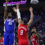 
              Philadelphia 76ers' Joel Embiid, left, shoots the ball over New Orleans Pelicans' Willy Hernangomez, center, during the first half of an NBA basketball game, Tuesday, Jan. 25, 2022, in Philadelphia. (AP Photo/Chris Szagola)
            