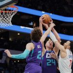 
              Charlotte Hornets center Mason Plumlee (24), and guard LaMelo Ball (2) battle for a rebound with Los Angeles Clippers guard Amir Coffey (7) during the first half of an NBA basketball game Sunday, Jan. 30, 2022, in Charlotte, N.C. (AP Photo/Rusty Jones)
            