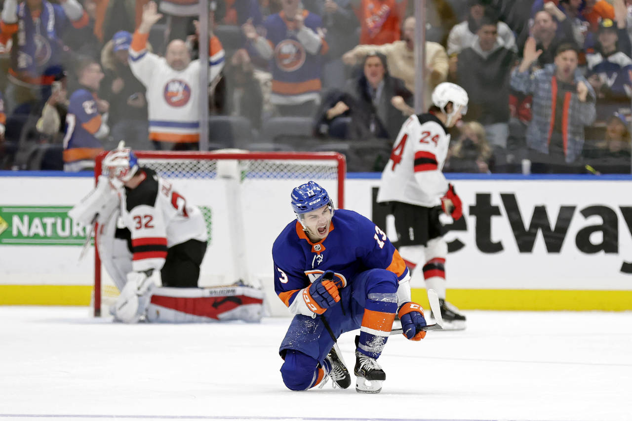 New York Islanders center Mathew Barzal (13) reacts after scoring the game winning goal past New Je...