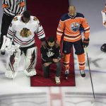 
              FILE - In this Aug. 1, 2020, file photo, Minnesota Wild's Matt Dumba takes a knee during the national anthem flanked by Chicago Blackhawks' Malcolm Subban, left, and Edmonton Oilers' Darnell Nurse, before an NHL hockey Stanley Cup playoff game in Edmonton, Alberta. Dumba, former NHL player Akim Aliu, Colorado’s Nazem Kadri, Toronto’s Wayne Simmonds and Florida’s Anthony Duclair are members of the recently formed Hockey Diversity Alliance. (Jason Franson/The Canadian Press via AP, File)
            