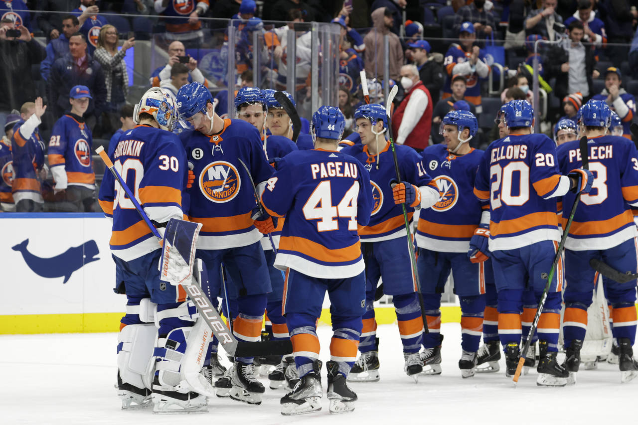 The New York Islanders celebrate their win with goaltender Ilya Sorokin (30) after an NHL hockey ga...