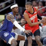 
              Houston Rockets guard Jalen Green, right, looks to pass the ball under pressure from Minnesota Timberwolves forward Jarred Vanderbilt, left, during the first half of an NBA basketball game Sunday, Jan. 9, 2022, in Houston. (AP Photo/Michael Wyke)
            
