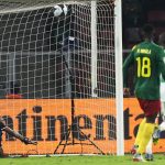 
              Comoros' goalkeeper Chaker Alhadhur, left, fails to stop a goal shot from Cameroon's Vincent Aboubakar, far right, during the African Cup of Nations 2022 round of 16 soccer match between Cameroon and Comoros at the Olembe stadium in Yaounde, Cameroon, Monday, Jan. 24, 2022. (AP Photo/Themba Hadebe)
            
