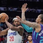 
              Los Angeles Clippers forward Justise Winslow (20) drives in the lane against Charlotte Hornets forward P.J. Washington (25) during the first half of an NBA basketball game Sunday, Jan. 30, 2022, in Charlotte, N.C. (AP Photo/Rusty Jones)
            