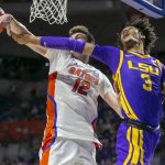 
              Florida forward Colin Castleton (12) and LSU forward Alex Fudge (3) go for a rebound during the first half of an NCAA college basketball game Wednesday, Jan. 12, 2022, in Gainesville, Fla. (AP Photo/Alan Youngblood)
            
