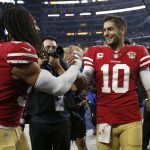 
              San Francisco 49ers middle linebacker Fred Warner, left, celebrates with quarterback Jimmy Garoppolo (10) after the 49ers defeated the Dallas Cowboys in an NFL wild-card playoff football game in Arlington, Texas, Sunday, Jan. 16, 2022. (AP Photo/Roger Steinman)
            