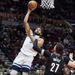 
              Minnesota Timberwolves center Karl-Anthony Towns, left, shoots over Portland Trail Blazers center Jusuf Nurkic during the second half of an NBA basketball game in Portland, Ore., Tuesday, Jan. 25, 2022. (AP Photo/Craig Mitchelldyer)
            