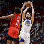 
              Golden State Warriors guard Klay Thompson (11) puts up a shot as Houston Rockets guard Jalen Green (0) defends during the first half of an NBA basketball game Monday, Jan. 31, 2022, in Houston. (AP Photo/Michael Wyke)
            