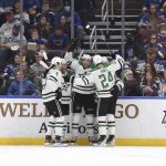 
              Dallas Stars left wing Jason Robertson (21), center, is congratulated after scoring a goal against the St. Louis Blues during the second period of an NHL hockey game Sunday, Jan. 9, 2022, in St. Louis. (AP Photo/Joe Puetz)
            