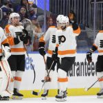 
              Philadelphia Flyers defenseman Keith Yandle (3) acknowledges the crowd after it is announced that he set NHL's record by playing in his 965th consecutive game in the first period of an NHL hockey game against the New York Islanders, Tuesday, Jan. 25, 2022, in Elmont, N.Y. (AP Photo/Corey Sipkin)
            