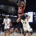 
              South Carolina forward Keyshawn Bryant (24) shoots as he collides with Vanderbilt guard Jamaine Mann (23) during an NCAA college basketball game Saturday, Jan. 8, 2022, in Nashville, Tenn. Bryant was called for charging on the play. (AP Photo/Wade Payne)
            