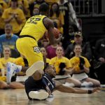 
              Marquette's Darryl Morsell (32) controls a loose ball in front of a diving Xavier's Paul Scruggs (1) during the first half of an NCAA college basketball game Sunday, Jan. 23, 2022, in Milwaukee. (AP Photo/Aaron Gash)
            