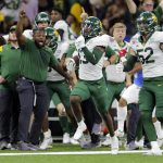 
              Baylor cornerback Al Walcott (13) runs 96 yards for a touchdown after intercepting a pass during the Sugar Bowl NCAA college football game against Mississippi Saturday, Jan. 1, 2022 in New Orleans. (David Grunfeld/The Times-Picayune/The New Orleans Advocate via AP)
            