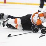 
              Philadelphia Flyers right wing Cam Atkinson (89) is tripped by Los Angeles Kings center Phillip Danault during the first period of an NHL hockey game Saturday, Jan. 1, 2022, in Los Angeles. (AP Photo/Kyusung Gong)
            