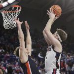 Gonzaga forward Drew Timme, right, shoots over Pepperdine forward Jan Zidek during the first half of an NCAA college basketball game Saturday, Jan. 8, 2022, in Spokane, Wash. (AP Photo/Young Kwak)
