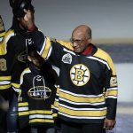 
              FILE - Former Boston Bruins' Willie O'Ree tips his hat as he is honored prior to the first period of an NHL hockey game against the Montreal Canadiens in Boston, Wednesday, Jan. 17, 2018. O'Ree says the ongoing pandemic hasn't diminished what he says will be a "simply amazing" honor watching his No. 22 jersey retired by the Bruins. O'Ree, who broke the NHL's color barrier on Jan. 18, 1958, was slated to attend when he became the 12th player in team history to have his number retired prior to Boston's game against Carolina on Tuesday, Jan. 18, 2022, But persisting concerns about the pandemic changed those plans. He will now participate from his home in San Diego.(AP Photo/Charles Krupa, File)
            