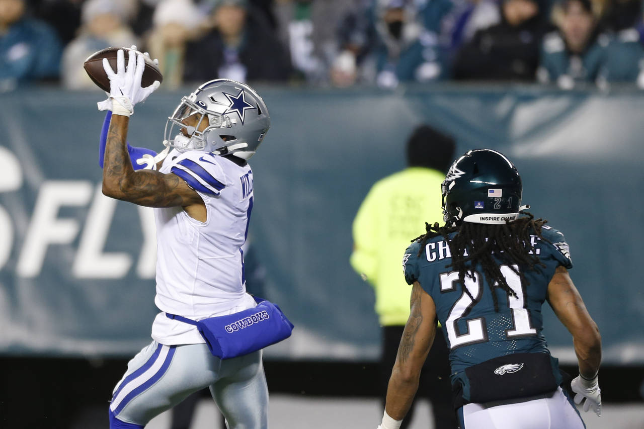 Dallas Cowboys wide receiver Ced Wilson catches a pass over Philadelphia Eagles defensive back Andr...