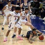 
              Notre Dame guard Blake Wesley, bottom right, comes up with the ball ahead of Howard guards Elijah Hawkins (3) and Deven Richmond (10) late in the second half of an NCAA college basketball game Monday, Jan. 17, 2022, in Washington. (Katherine Frey/The Washington Post via AP)
            
