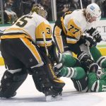 
              Dallas Stars center Joe Pavelski (16) falls to the ice against Pittsburgh Penguins defender Jeff Carter (77) and goaltender Tristan Jarry (35) during the first period of an NHL hockey game in Dallas, Saturday, Jan. 8, 2022. (AP Photo/LM Otero)
            