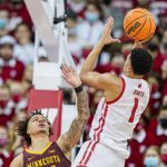 
              Wisconsin's Johnny Davis (1) shoots against Minnesota's Sean Sutherlin (24) during the first half of an NCAA college basketball game Sunday, Jan. 30, 2022, in Madison, Wis. (AP Photo/Andy Manis)
            