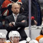 
              Philadelphia Flyers interim head coach Mike Yeo looks on during the third period of an NHL hockey game against the New York Islanders, Tuesday, Jan. 25, 2022, in Elmont, N.Y. (AP Photo/Corey Sipkin).
            