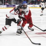 
              Canada's Mason McTavish (23) and Czech Republic's Jiri Kulich (27) battle for the puck during third-period IIHF world junior hockey championship game action in Edmonton, Alberta, Sunday, Dec. 26, 2021. (Jason Franson/The Canadian Press via AP)
            