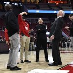 
              Referee Roger Ayers, center, and officials from the University of Louisville and from the KFC Yum! Center look at a leak over the court before the scheduled start of an NCAA college basketball game between Boston College and Louisville in Louisville, Ky., Wednesday, Jan. 19, 2022. (AP Photo/Timothy D. Easley)
            