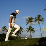 
              Haotong Li, of China, reacts to his double bogey on the 16th green during the third round of the Sony Open golf tournament, Saturday, Jan. 15, 2022, at Waialae Country Club in Honolulu. (AP Photo/Matt York)
            