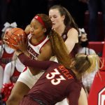 
              North Carolina State's Kayla Jones, left, controls a rebound between Virginia Tech's Elizabeth Kitley (33) and Cayla King, top right, during the first half of an NCAA college basketball game, Sunday, Jan. 23, 2022, in Raleigh, N.C. (AP Photo/Karl B. DeBlaker)
            