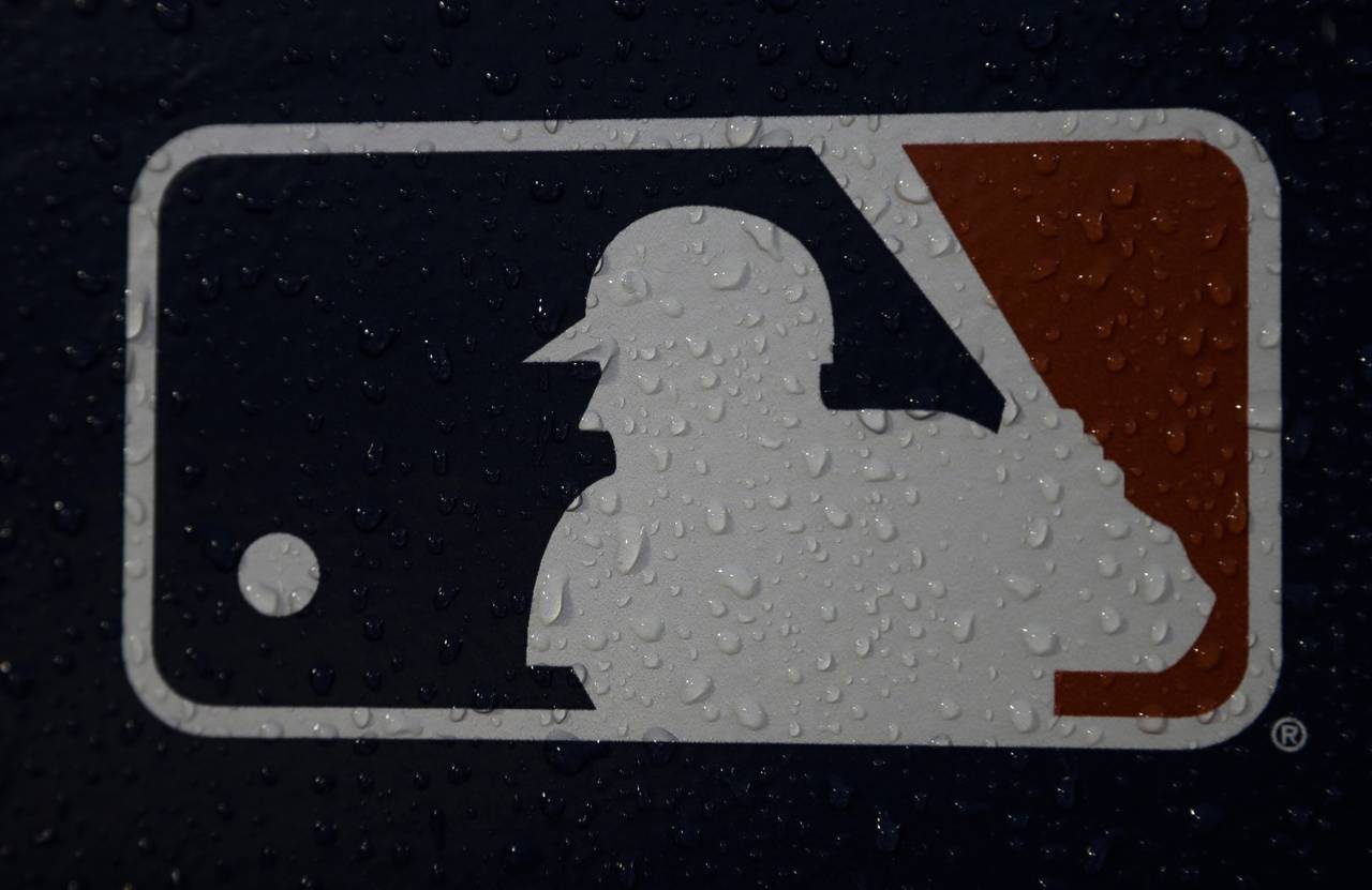 FILE - A rain-covered logo is seen at Fenway Park before Game 1 of the World Series baseball game b...