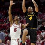 
              Missouri guard Javon Pickett (4) drives past Arkansas guard Au'Diese Toney (5) to score during the second half of an NCAA college basketball game Wednesday, Jan. 12, 2022, in Fayetteville, Ark. (AP Photo/Michael Woods)
            