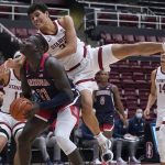 
              Arizona center Oumar Ballo (11) is fouled by Stanford forward Brandon Angel, top, during the second half of an NCAA college basketball game in Stanford, Calif., Thursday, Jan. 20, 2022. (AP Photo/Jeff Chiu)
            