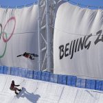 
              FILE - A snowboarder catches air while training on the half pipe ahead of the 2022 Winter Olympics, Jan. 27, 2022, in Zhangjiakou, China. Beijing will become the first city to host both versions of the Games. (AP Photo/Jae C. Hong, File)
            