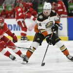 
              Anaheim Ducks defenseman Jamie Drysdale, right, passes the puck away from Detroit Red Wings center Joe Veleno during the second period of an NHL hockey game Monday, Jan. 31, 2022, in Detroit. (AP Photo/Jose Juarez)
            