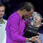 
              Rafael Nadal of Spain kisses the Norman Brookes Challenge Cup after defeating Daniil Medvedev of Russia in the men's singles final at the Australian Open tennis championships in Melbourne, Australia, early Monday, Jan. 31, 2022. (AP Photo/Andy Brownbill)
            