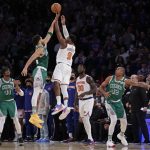 
              New York Knicks guard RJ Barrett (9) makes the game-winning 3-point basket in front of Boston Celtics forward Jayson Tatum during an NBA basketball game Thursday, Jan. 6, 2022, in New York. The Knicks won 108-105. (AP Photo/Adam Hunger)
            
