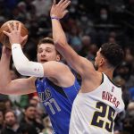 
              Dallas Mavericks guard Luka Doncic (77) looks to shoot against Denver Nuggets guard Austin Rivers (25) during the first quarter of an NBA basketball game in Dallas, Monday, Jan. 3, 2022. (AP Photo/LM Otero)
            
