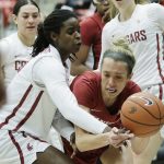 
              Stanford guard Lexie Hull, right, fights for control of a rebound against Washington State center Bella Murekatete during the first half of an NCAA college basketball game, Sunday, Jan. 2, 2022, in Pullman, Wash. (AP Photo/Young Kwak)
            