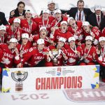 
              FILE - Canada celebrates defeating the United States in overtime in the IIHF hockey women's world championships title game in Calgary, Alberta, Tuesday, Aug. 31, 2021. The United States is the defending Olympic champion after beating Canada in an exceptionally nail-biting 3-2 shootout win at South Korea in 2018 to end Canada's run of four gold medals. And yet, Canada is the reigning world champion after punching back with a 3-2 overtime gold-medal win in Calgary, Alberta, in August to end USA's run of five consecutive titles.(Jeff McIntosh/The Canadian Press via AP, File)
            