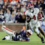 
              FILE - Alabama running back Brian Robinson Jr. (4) carries the ball against Auburn during the second half of an NCAA college football game Nov. 27, 2021, in Auburn, Ala. Alabama plays Georgia in the College Football Playoff national championship game on Jan. 10, 2022. (AP Photo/Butch Dill, File)
            