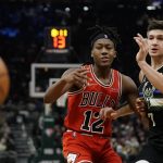 
              Chicago Bulls' Ayo Dosunmu and Milwaukee Bucks' Grayson Allen go after a loose ball during the first half of an NBA basketball game Friday, Jan. 21, 2022, in Milwaukee. (AP Photo/Morry Gash)
            