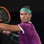 
              Rafael Nadal of Spain plays a backhand return to Matteo Berrettini of Italy during their semifinal match at the Australian Open tennis championships in Melbourne, Australia, Friday, Jan. 28, 2022. (AP Photo/Simon Baker)
            