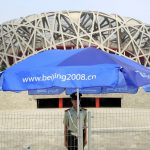 
              FILE - A Chinese paramilitary police officer stands in the shade on a hot day while guarding the National Stadium, July 23, 2008, in Beijing. Beijing will become the first city to host both versions of the Games.  (AP Photo/Robert F. Bukaty, File)
            