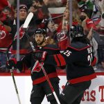 
              Carolina Hurricanes' Vincent Trocheck (16) celebrates his goal with teammate Ethan Bear (25) during the first period of an NHL hockey game against the San Jose Sharks in Raleigh, N.C., Sunday, Jan. 30, 2022. (AP Photo/Karl B DeBlaker)
            