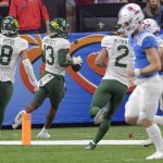 
              Baylor cornerback Al Walcott (13) returns an interception for 96 yards against Mississippi quarterback Luke Altmyer (7), right, during the first half of the Sugar Bowl NCAA college football game in New Orleans, Saturday, Jan. 1, 2022. (AP Photo/Matthew Hinton)
            